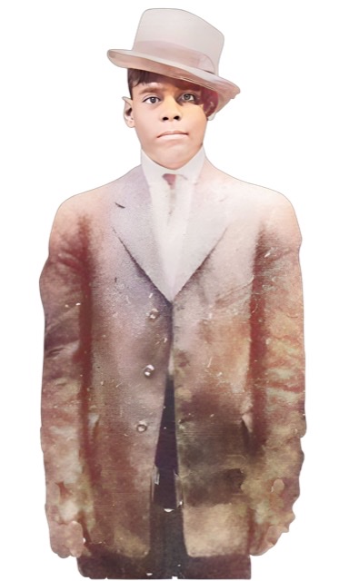 An enhanced and colorized photograph of a cap wearing Kid Rena standing and facing camera wearing a long great coat with his arms down by his sides.