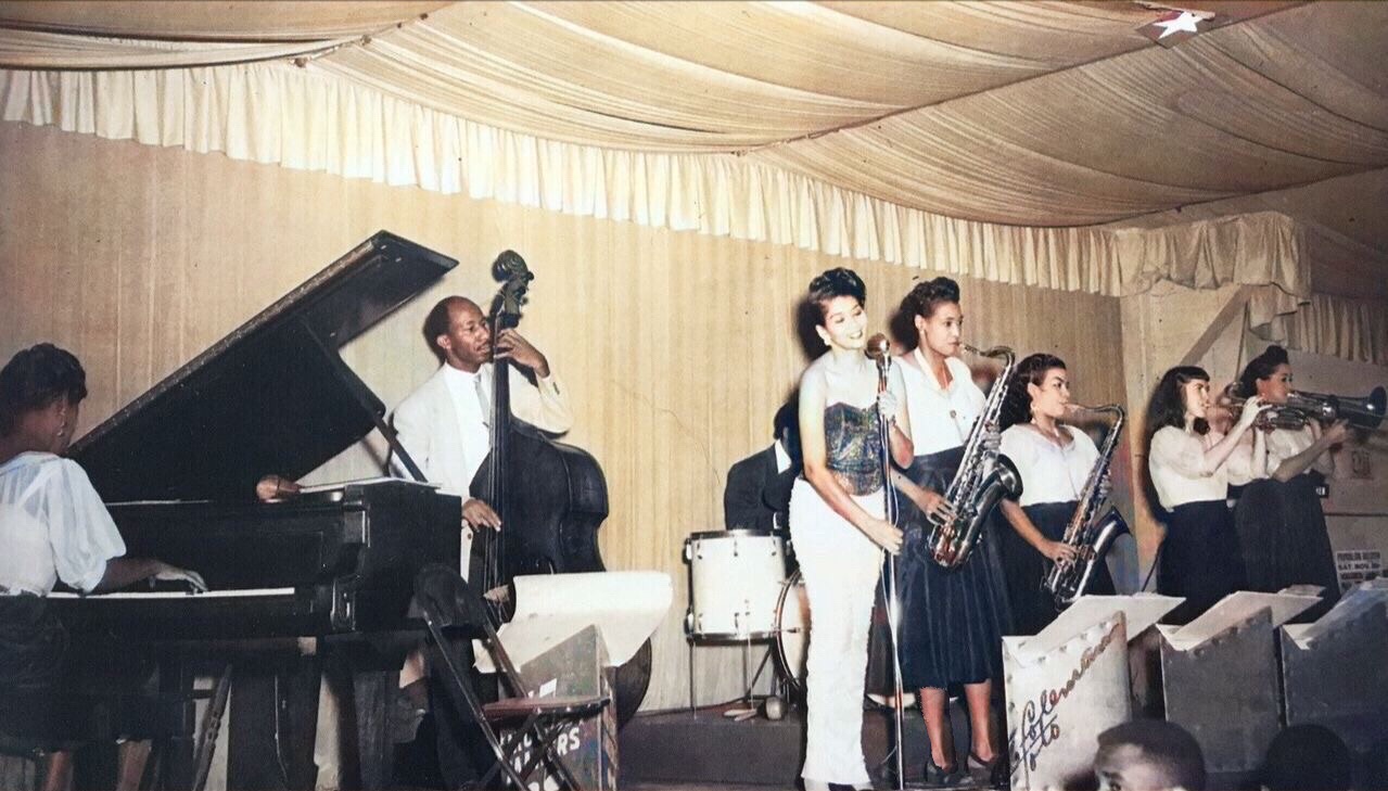 A colorized photo of the almost all woman band at the Palomar ballroom.