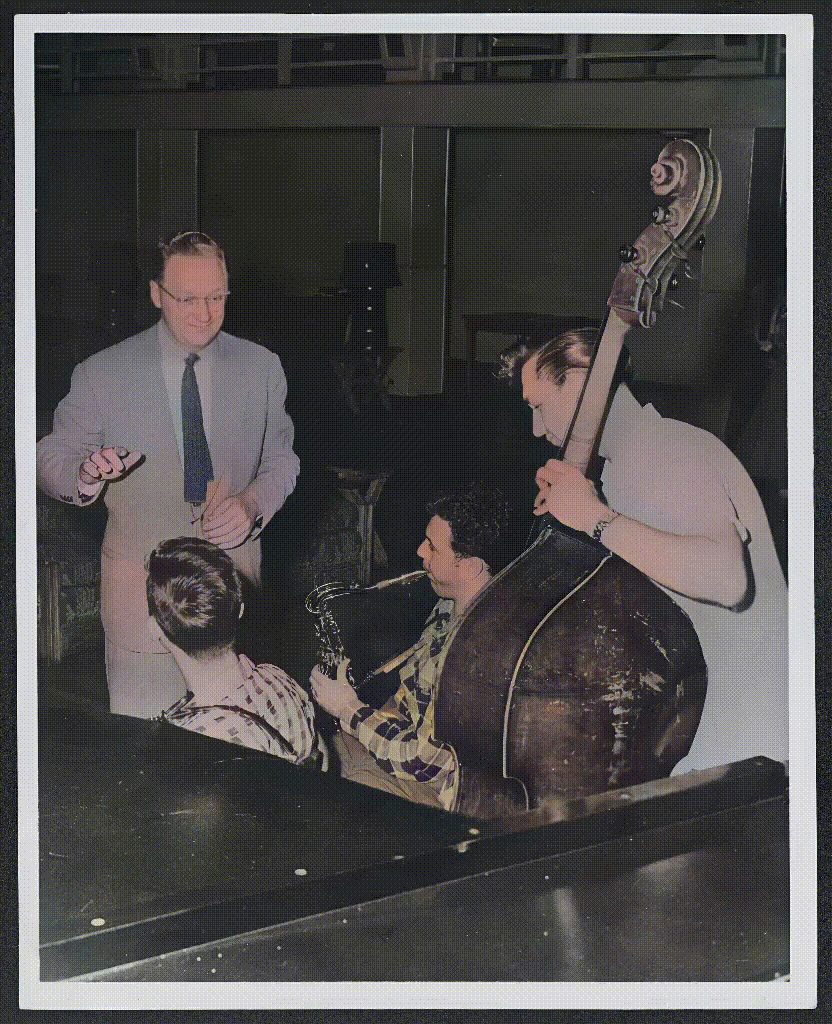 A colorized and animated photograph of Dr. M. E. "Gene" Hall conducting three jazz students in the (jazz) dance band at the University of North Texas College of Music in 1947.