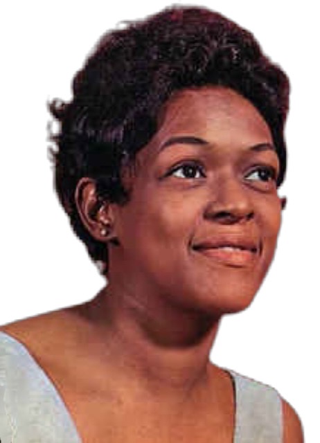 Organist Shirley Scott gazing forward as a young woman while seated.