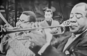 Dizzy Gillespie and Louis Armstrong playing trumpets on Timex All-Star Jazz Show in 1959.