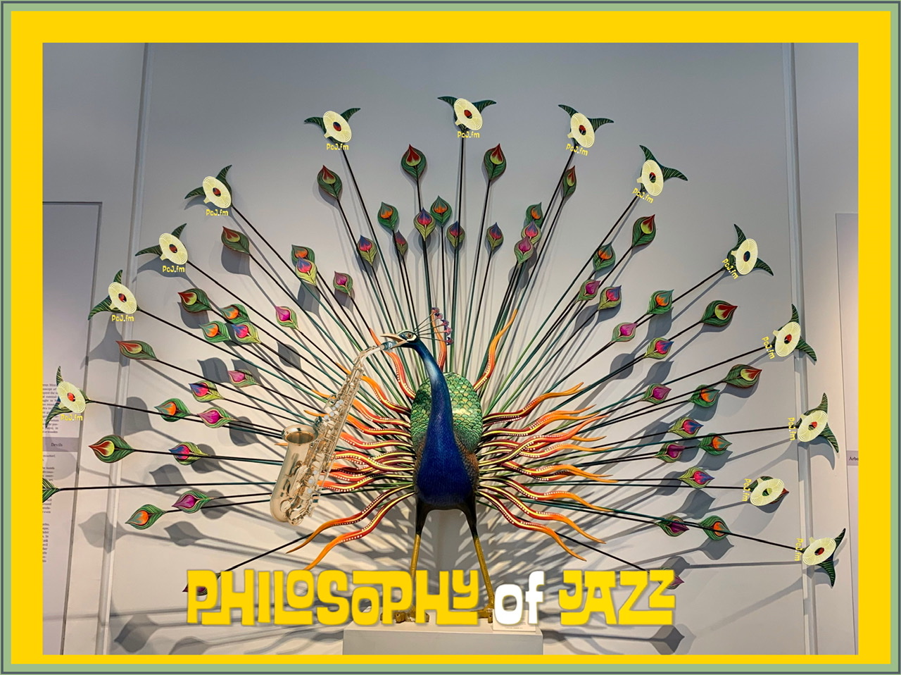A photograph of an artwork peacock made of glass in Mexico City, Mexico at the Museo de Arte Popular showing the outermost peacock feathers having a PoJ.fm logo and at the foot of the graphic are the words Philosophy of Jazz written in yellow with an outer light green border and a thicker yelllow inner border.