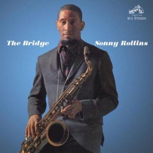 The album cover for "The Bridge" by saxophonist Sonny Rollins facing forward on the cover with a saxophone on a lanyard.