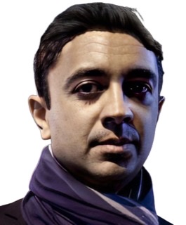 An enhanced color photographic cutout of Vijay Iyer's face turned toward the viewer while he wears a purple jacket.