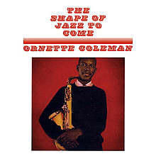 The album cover for "The Shape of Jazz to Come" by Ornette Coleman with the title and his name in red font centered at top third of album cover and Ornette Coleman standing holding his saxophone with a red background.