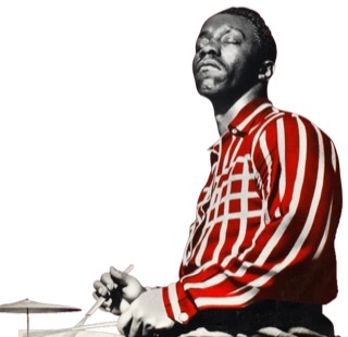 A young Art Blakey with a striped shirt sitting sideways eyes closed facing left playing with brushes.