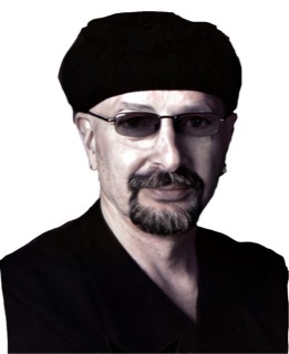 An enhanced color photograph of goateed Steve Smith wearing tinted glasses, a v-neck black shirt, and a black beret while facing camera.
