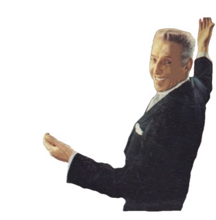 Stan Kenton in color raising his right hand high with his back to camera and head turned to left with a big smile.