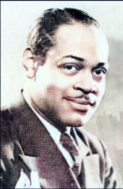 A photograph of a smiling Coleman Hawkins's head.